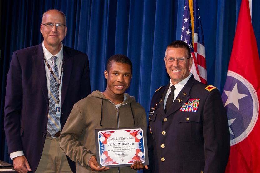 A student is honored for serving in the US Armed Forces after high school